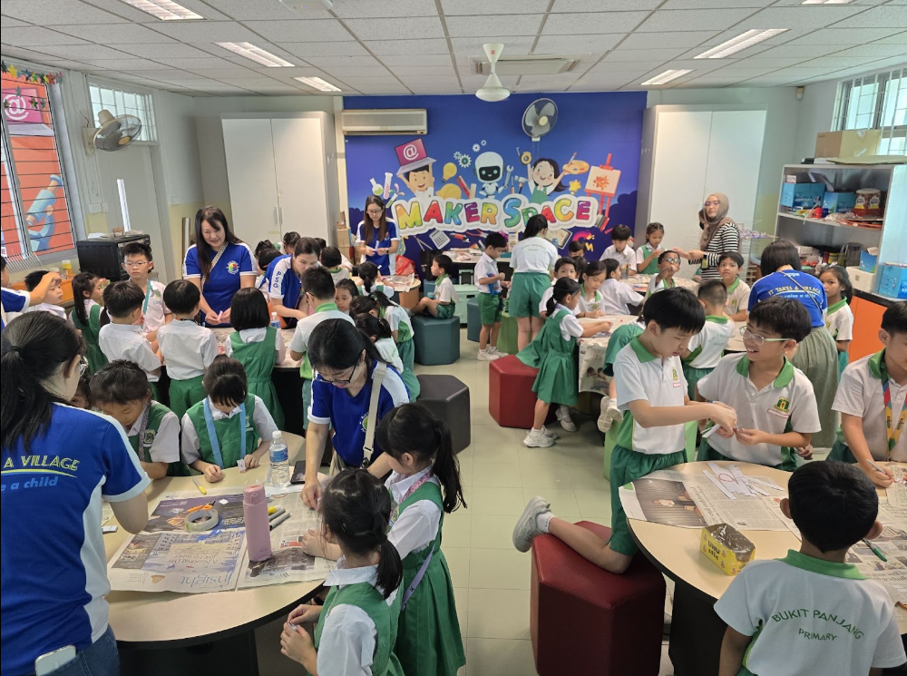 Parent Volunteers with group of students at makerspace carrying out their projects